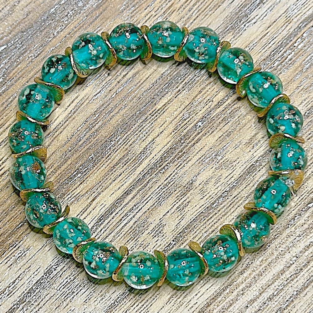 Lake blue firefly 8mm glass beaded bracelet with gold filled wavy spacer beads